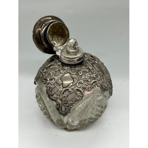 503 - A silver and glass scent bottle with, obscure hallmark.