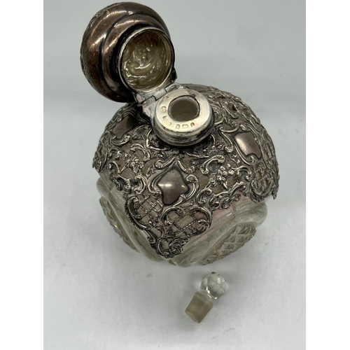 503 - A silver and glass scent bottle with, obscure hallmark.