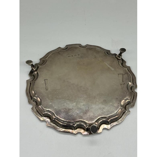 504 - An engraved silver tray on three hoof feet,by Adie Brothers Ltd Birmingham 1932 approximate weight 1... 