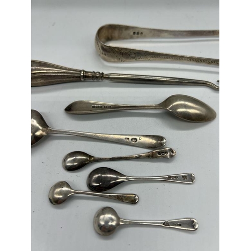 506 - A selection of hallmarked silver items to include teaspoons, mustard spoons, sugar tongs and a silve... 