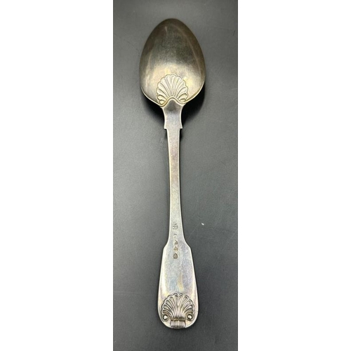 509 - A fiddle and shell silver table spoon, hallmarked for London 1815 by William Eley I & William Fearn,... 