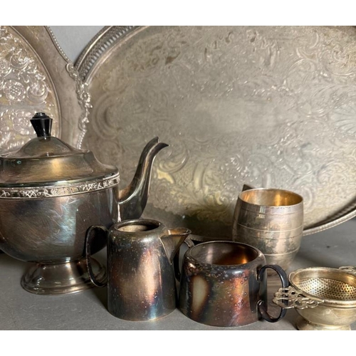 524 - A selection of silver plate and white metal items to include trays, tea pot and a Harrords tea strai... 