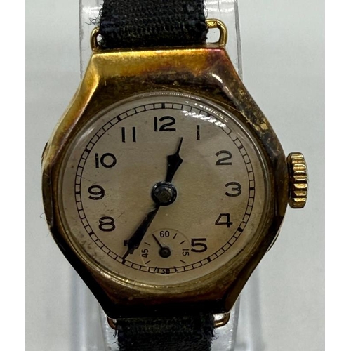 644 - An 18ct gold ladies watch on a fabric strap.