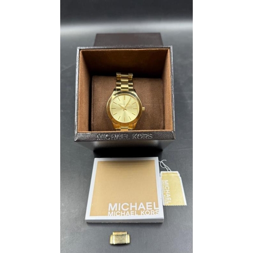 664 - A Michael Kors slim runway 42mm three hand movement ladies wristwatch in stainless steel gold, boxed