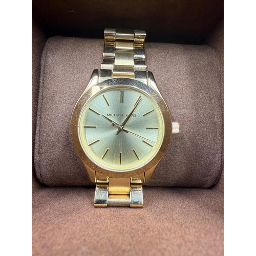 664 - A Michael Kors slim runway 42mm three hand movement ladies wristwatch in stainless steel gold, boxed