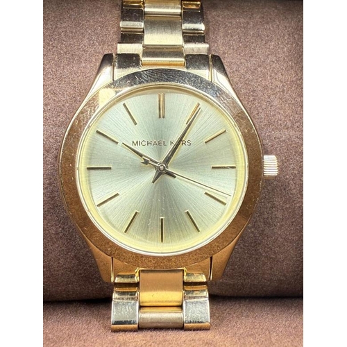 664 - A Michael Kors slim runway 42mm three hand movement ladies wristwatch in stainless steel gold, boxed