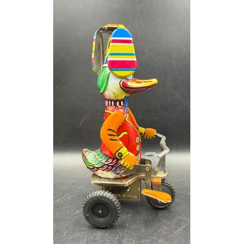 828 - A Vintage 'Duck on a Bike' tinplate toy in box