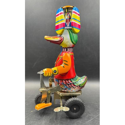 828 - A Vintage 'Duck on a Bike' tinplate toy in box