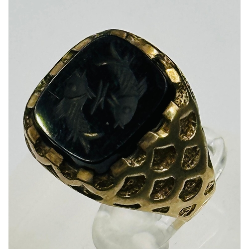 621 - A 9ct gold ring with fish engraved stone, approximate weight 5.1g and size S