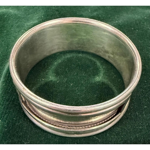 500A - A hallmarked silver napkin ring along with a Krupp Bergdorf 'Hotel Rosat' napkin ring