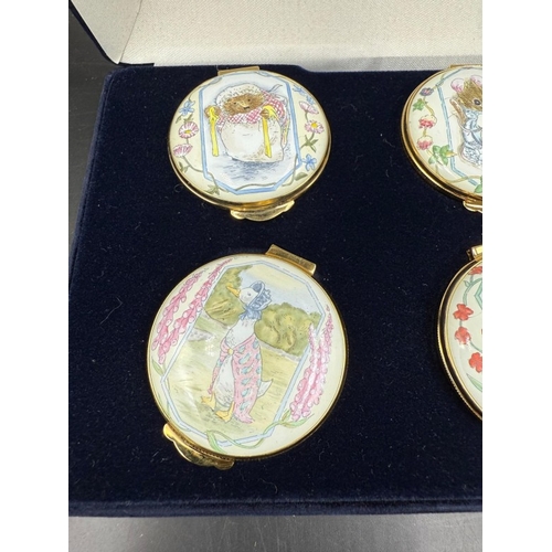 303 - A boxed set of six Royal Doulton enamel pill pots