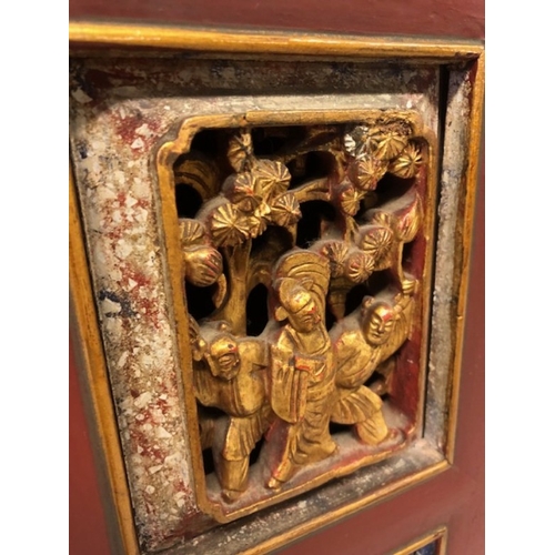 42 - Chinese wedding cabinet of red and gold lacquer, the front panels and doors profusely carved in pier... 