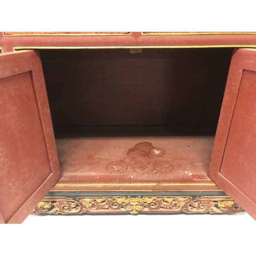 42 - Chinese wedding cabinet of red and gold lacquer, the front panels and doors profusely carved in pier... 