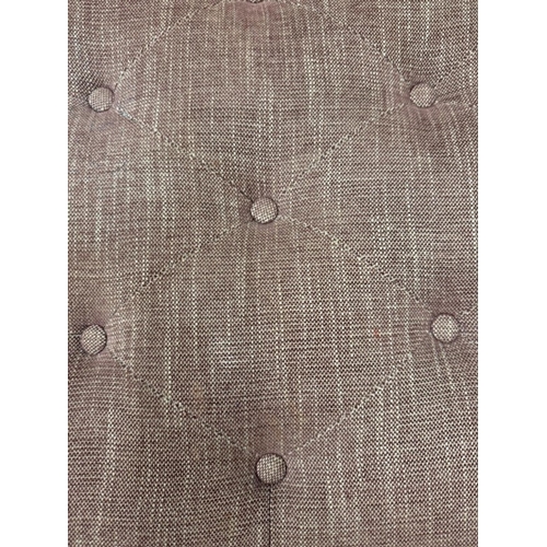 56 - A button topped ottoman, upholstered in a purple and white flecked fabric