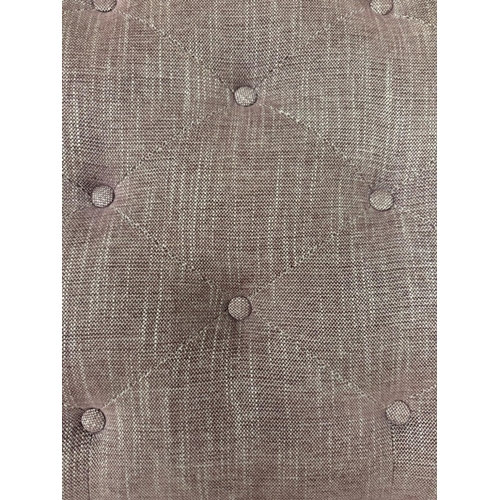 56 - A button topped ottoman, upholstered in a purple and white flecked fabric