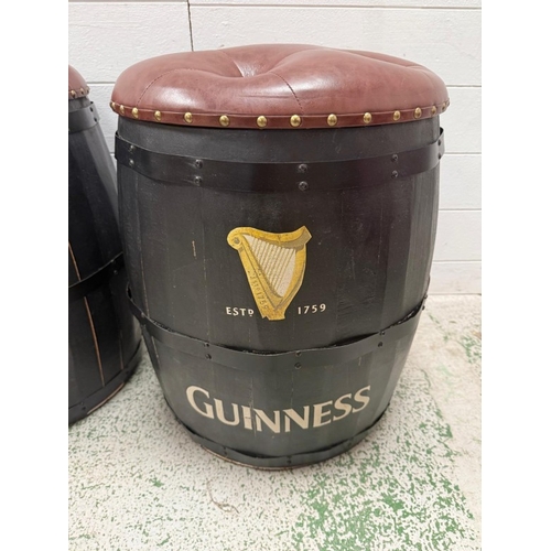 A pair of Guinness barrel stools with studded faux brown leather seats