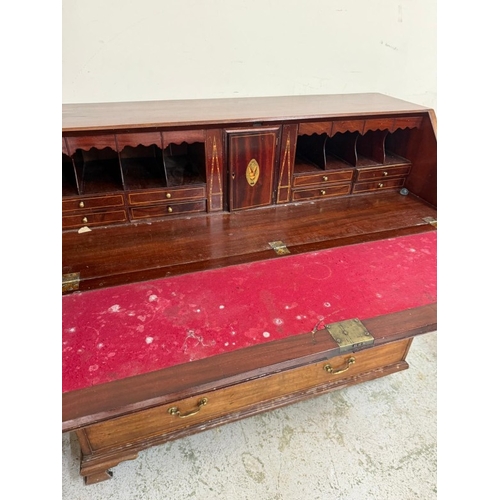 25 - A mahogany bureau comprising of two short drawers over three graduated long, the fall opening to pig... 