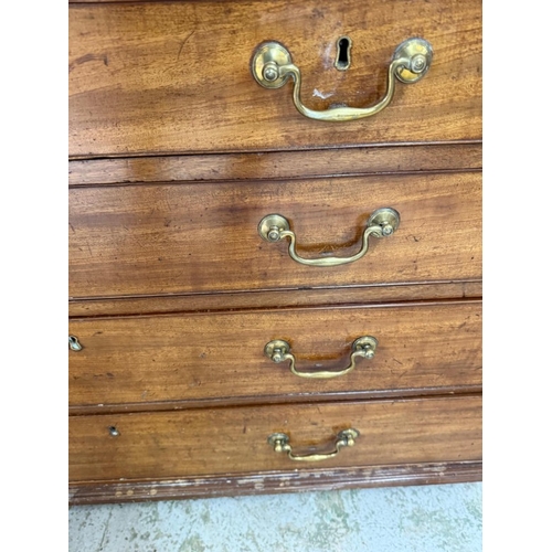 25 - A mahogany bureau comprising of two short drawers over three graduated long, the fall opening to pig... 