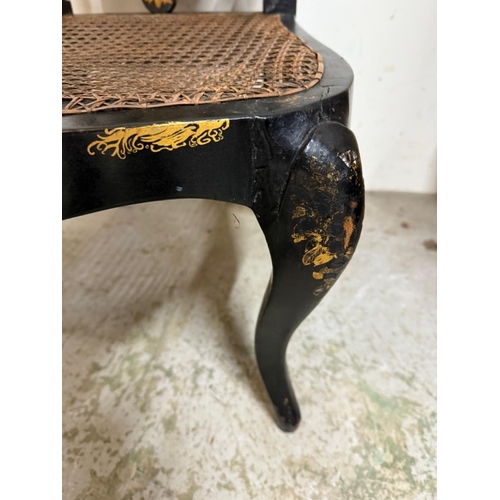 27 - A black lacquer hall chair with mother of pearl inlay, barley twist supports and wicker seat