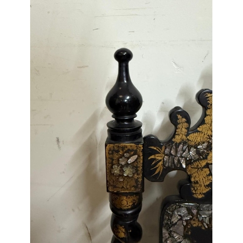 27 - A black lacquer hall chair with mother of pearl inlay, barley twist supports and wicker seat