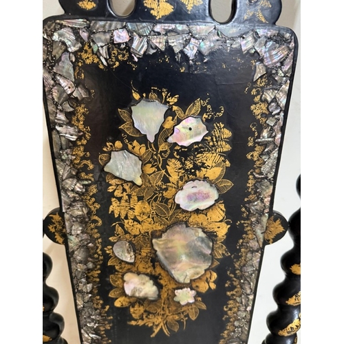 27 - A black lacquer hall chair with mother of pearl inlay, barley twist supports and wicker seat