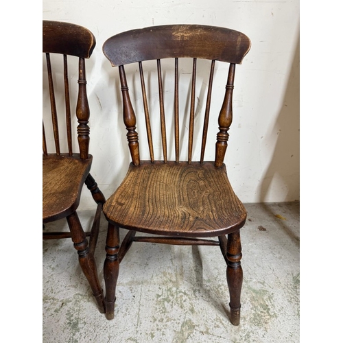 29 - A Windsor open arm chair and two spindle back dining chairs