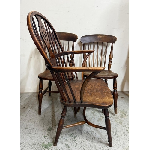 29 - A Windsor open arm chair and two spindle back dining chairs