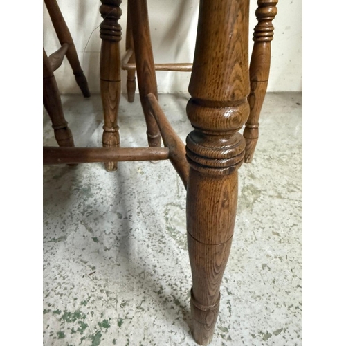 30 - Three oak bar back kitchen chairs on turned legs and with turned spindles