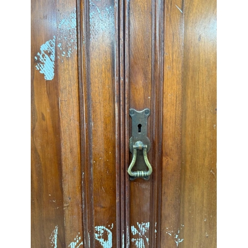 121 - A mahogany linen press comprising of a two over two chest witha two door cupboard over H197cm W122cm... 