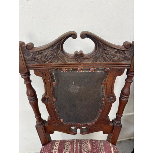 129 - A harlequin set of three carved hall chairs