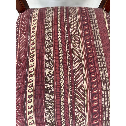 129 - A harlequin set of three carved hall chairs
