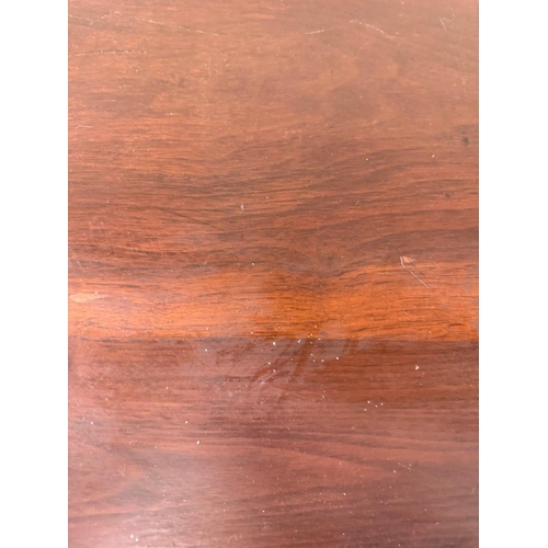 130 - A mahogany octagonal occasional table on fluted legs with a shelf under H68cm W80cm D80cm