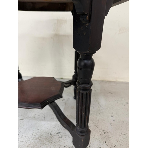 130 - A mahogany octagonal occasional table on fluted legs with a shelf under H68cm W80cm D80cm