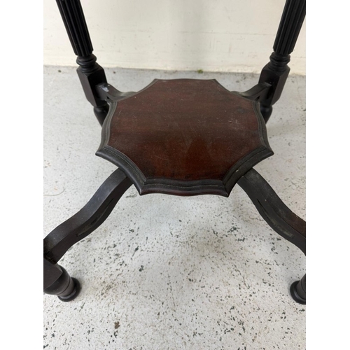 130 - A mahogany octagonal occasional table on fluted legs with a shelf under H68cm W80cm D80cm