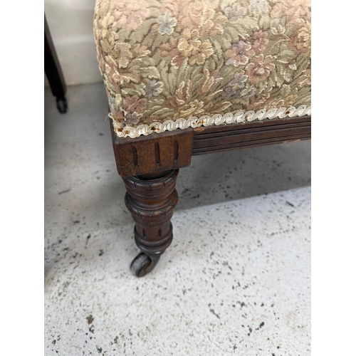 131 - A pair of mahogany-framed his and her fireside chairs in a floral damask fabric