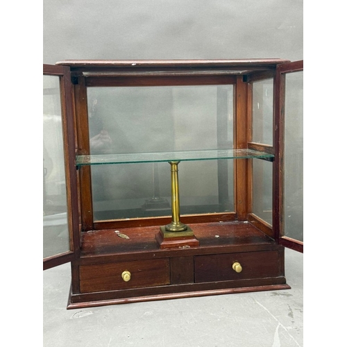 133 - A mahogany-glazed table top display cabinet with two drawers under