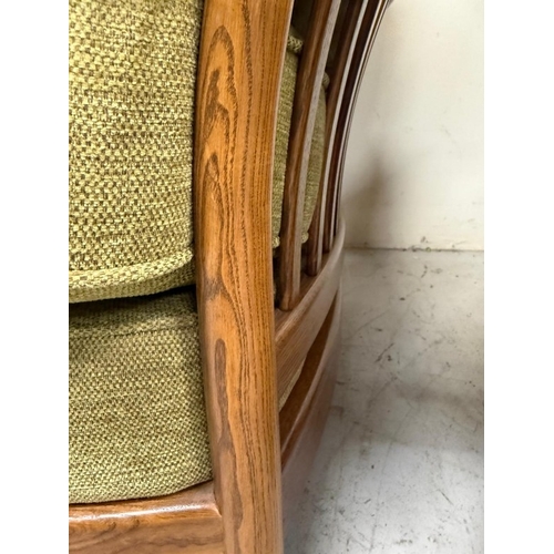 137 - An Ercol three-piece suite upholstered in green