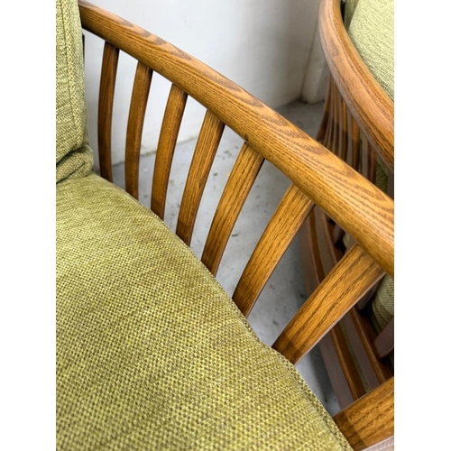 137 - An Ercol three-piece suite upholstered in green
