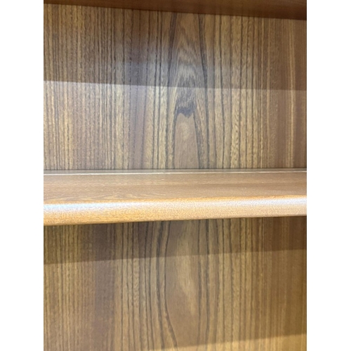 138 - An Ercol mural two-door display cabinet over a two-door cupboard H197cm W98cm D49