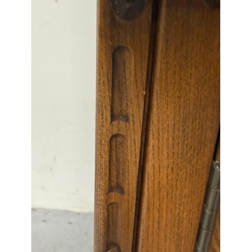 138 - An Ercol mural two-door display cabinet over a two-door cupboard H197cm W98cm D49