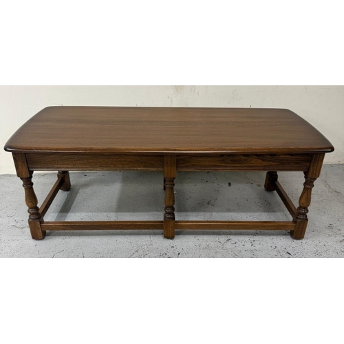 145 - A Mid Century dark Ercol coffee table with two nesting tables under. H42cm W119cm D49cm