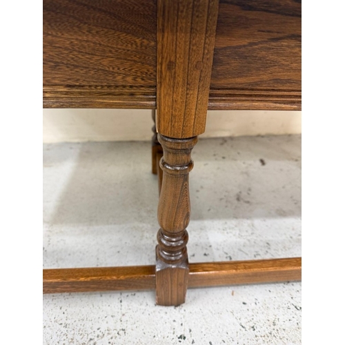 145 - A Mid Century dark Ercol coffee table with two nesting tables under. H42cm W119cm D49cm