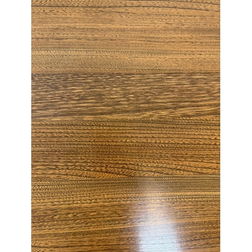 145 - A Mid Century dark Ercol coffee table with two nesting tables under. H42cm W119cm D49cm
