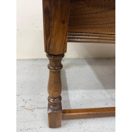 145 - A Mid Century dark Ercol coffee table with two nesting tables under. H42cm W119cm D49cm