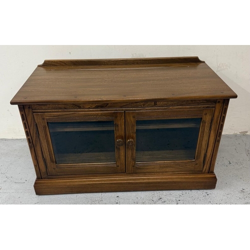 147 - A dark Ercol Tv or media unit with glazed two door cupboard under H56cm W97cm D50cm