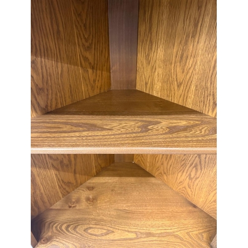 148 - A dark Ercol free-standing corner cabinet with three shelves over a single door cupboard H184cm W72c... 