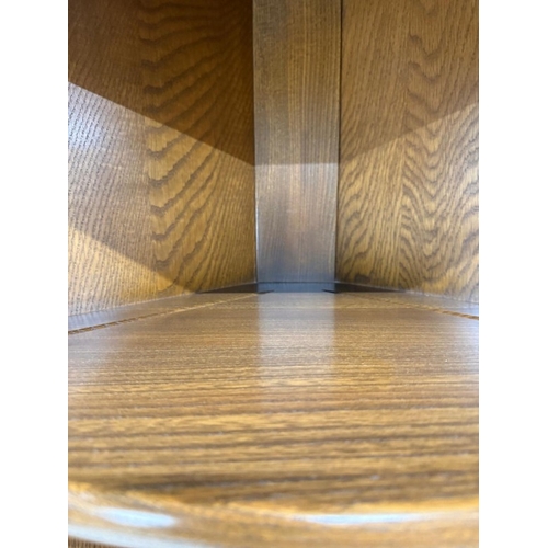 148 - A dark Ercol free-standing corner cabinet with three shelves over a single door cupboard H184cm W72c... 