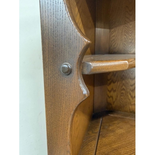 148 - A dark Ercol free-standing corner cabinet with three shelves over a single door cupboard H184cm W72c... 