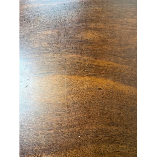 150 - A mahogany extendable dining table on turned legs and a set of six oak framed dining chairs with red... 