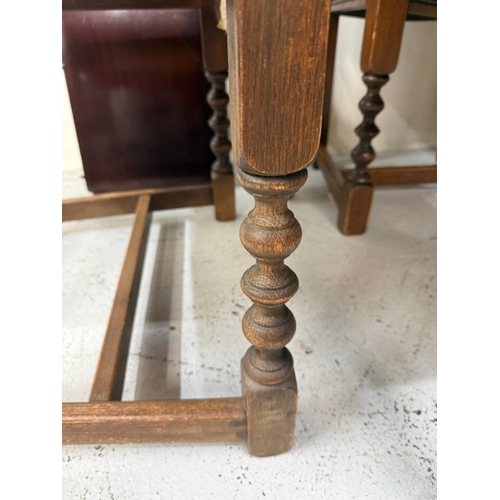 150 - A mahogany extendable dining table on turned legs and a set of six oak framed dining chairs with red... 